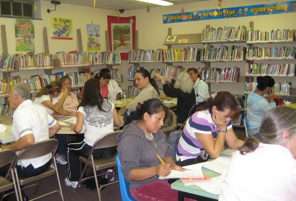 Adult learners studying together at a table during an adult education class